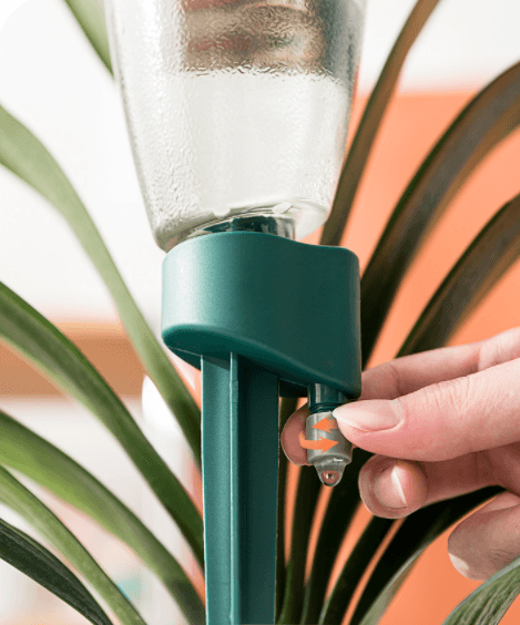 Automatic drip irrigator with a bottle for flowers and potted plants - blue
