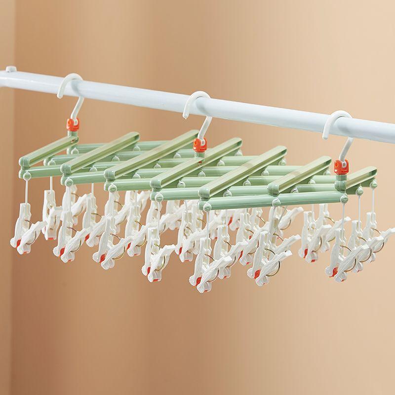 Plastic foldable clothes hanger with clips - 14 clips - green
