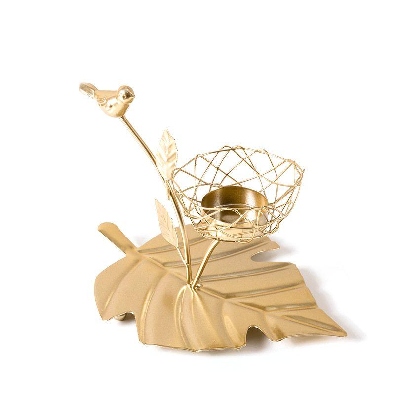 Decorative golden candlestick - a basket on a leaf